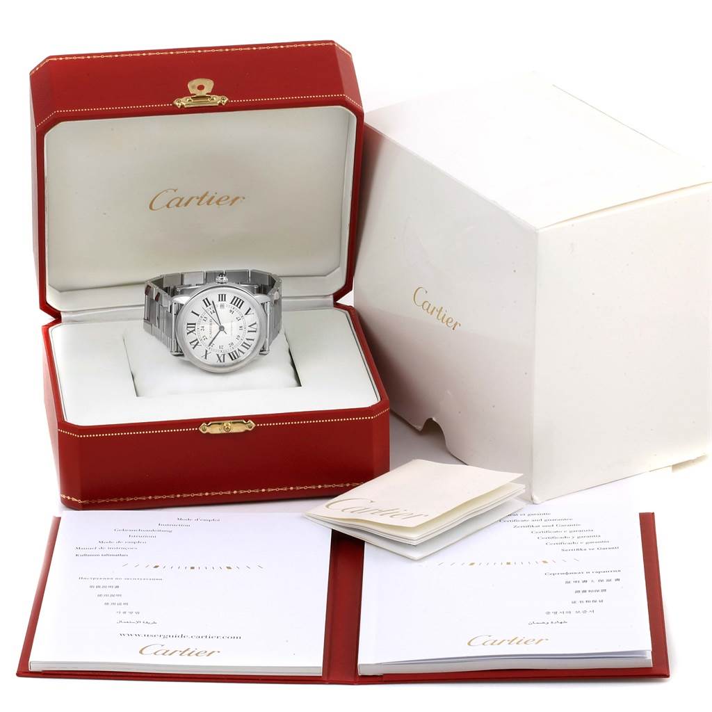 The image shows a Cartier Ronde W6701011 Men's Stainless Steel Silver Dial W6701011 Men's Stainless Steel Silver Dial watch inside its open box with accompanying documents and packaging.