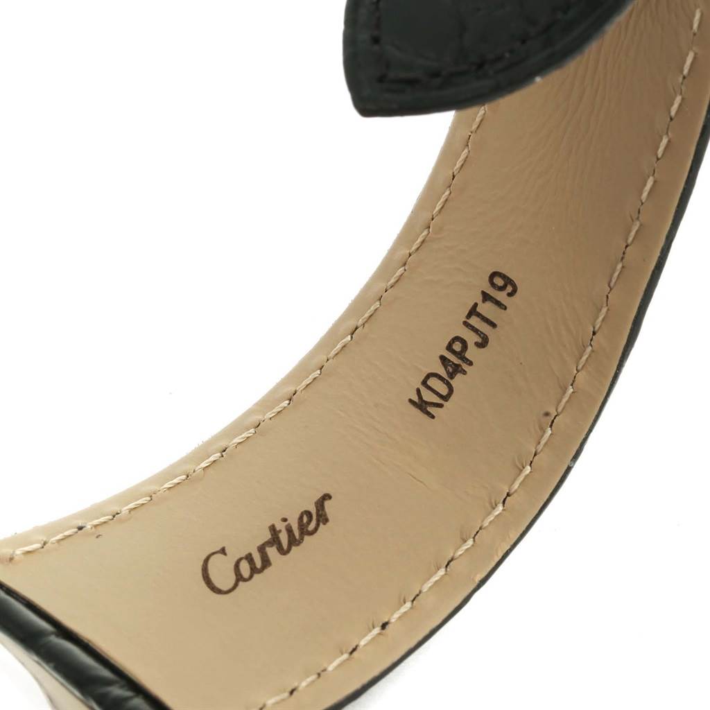 The image shows the underside of the strap of a Cartier Ronde W6701010 Men's Stainless Steel Silver Dial W6701010 Men's Stainless Steel Silver Dial model watch, displaying the brand name and serial number.