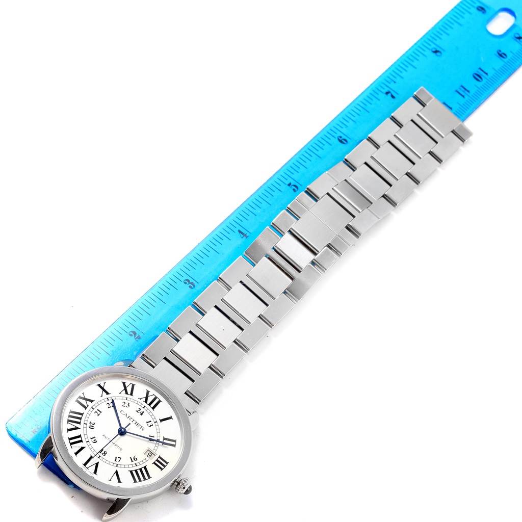The image shows the face and metal bracelet of a Cartier Ronde W6701011 Men
s Stainless Steel Silver Dial W6701011 Men
s Stainless Steel Silver Dial model watch, next to a measuring ruler.