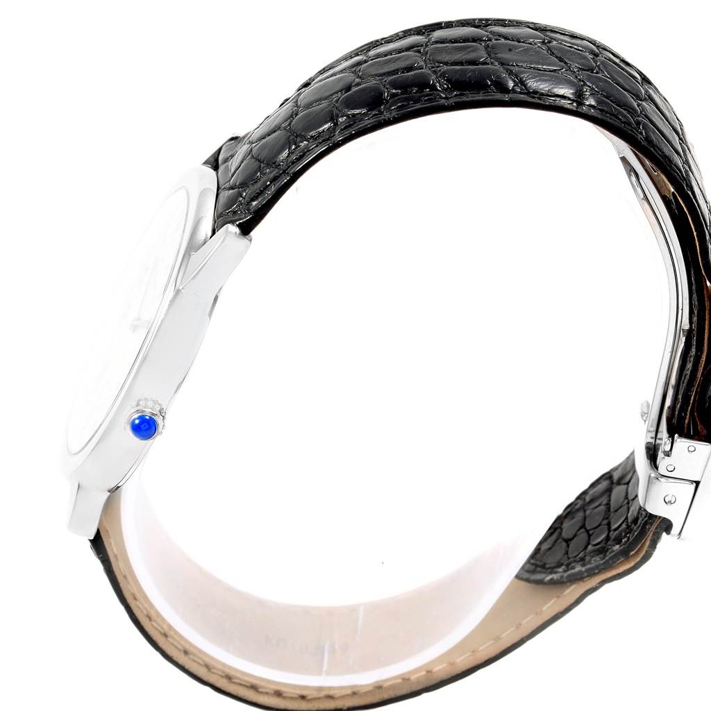 This image shows the side profile of a Cartier Ronde W6700255 Stainless Steel Silver Dial W6700255 Stainless Steel Silver Dial watch, highlighting its case, crown with blue gem, and black leather strap.