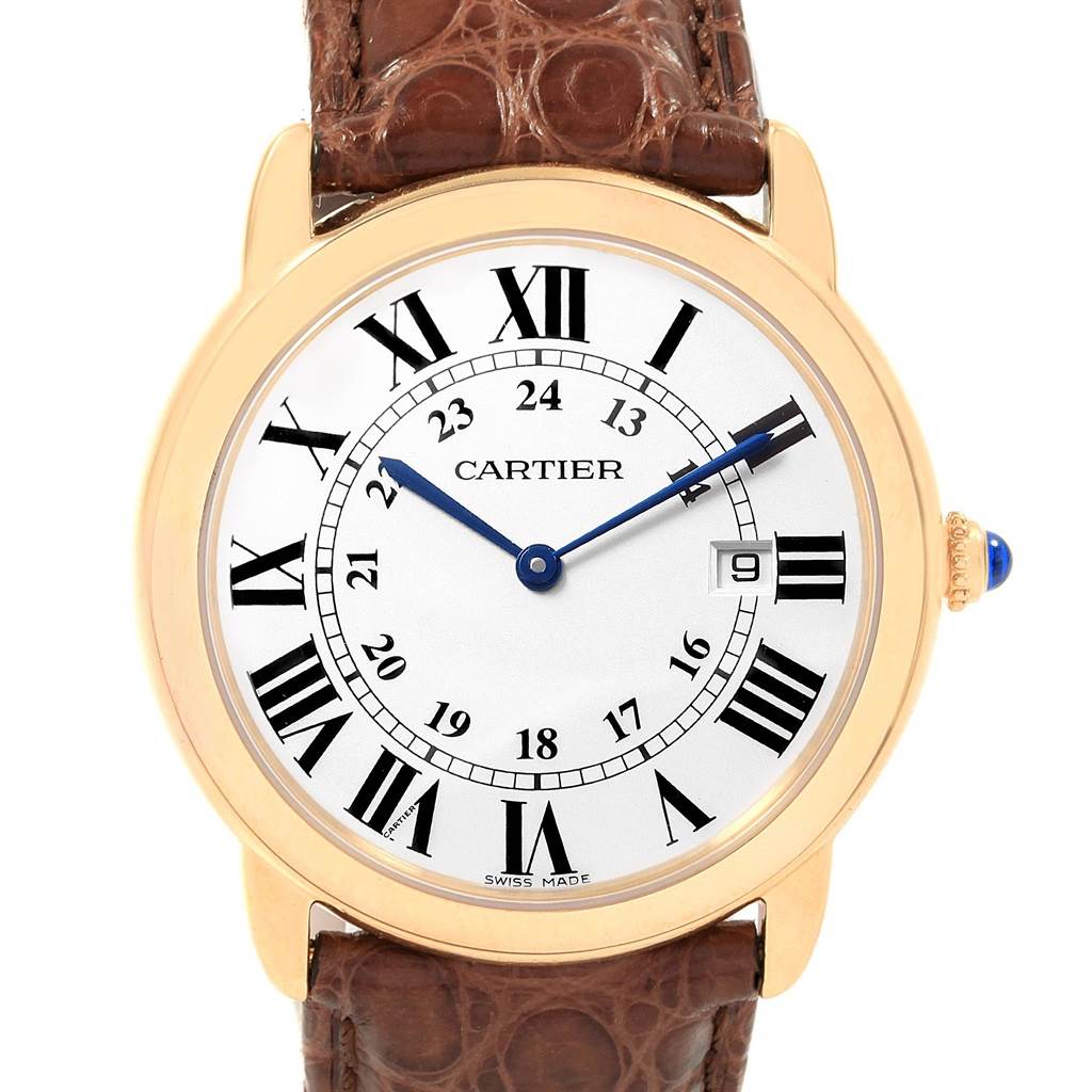 The image shows a frontal view of a Cartier Ronde W6700455 Men's Steel and Gold (two tone) Silver Dial W6700455 Men's Steel and Gold (two tone) Silver Dial watch, highlighting its brown leather strap, gold case, and Roman numeral dial.
