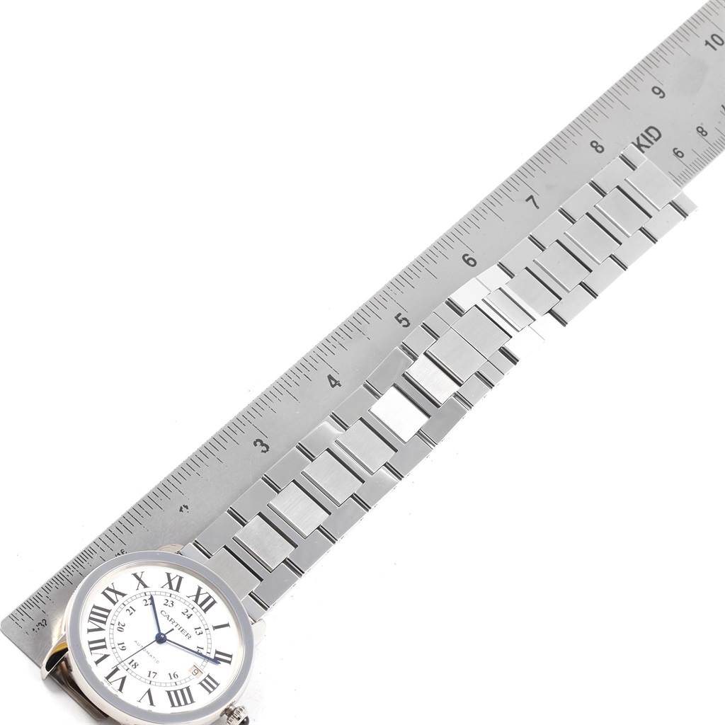 The image shows a Cartier Ronde W6701011 Men
s Stainless Steel Silver Dial W6701011 Men
s Stainless Steel Silver Dial watch face and part of its metal bracelet, measured against a ruler.