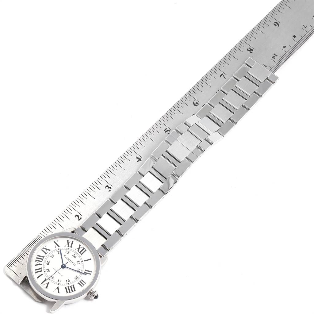 The image shows a top-down view of a Cartier Ronde W6701011 Men's Stainless Steel Silver Dial W6701011 Men's Stainless Steel Silver Dial watch and its metal bracelet alongside a ruler for size reference.