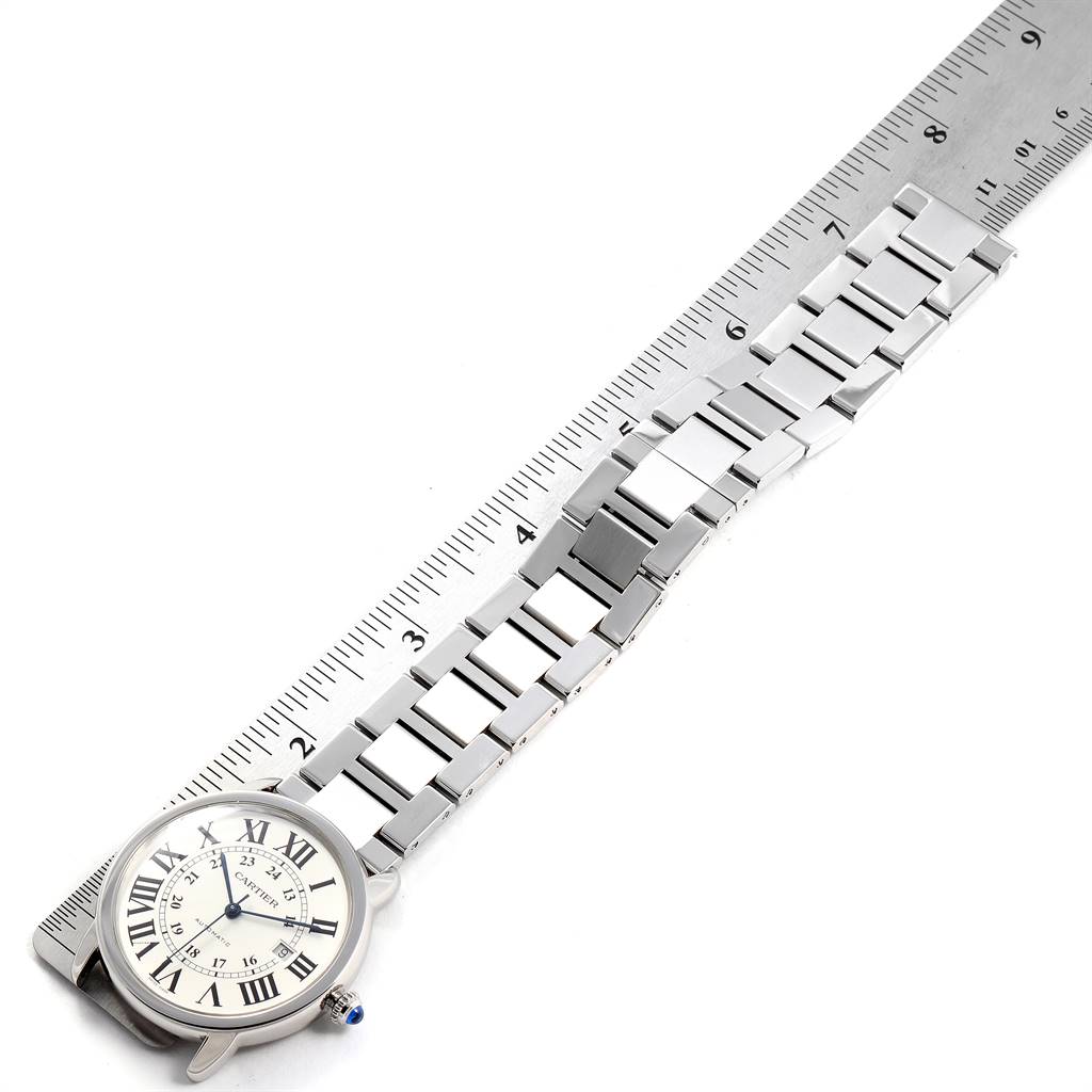 The Cartier Ronde W6701011 Men
s Stainless Steel Silver Dial W6701011 Men
s Stainless Steel Silver Dial model watch is shown from a top view, displaying its face and metal bracelet alongside a ruler.