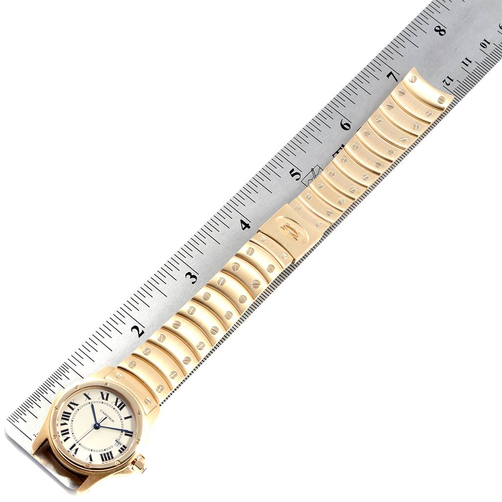 The image shows a Cartier Santos W20028G1 Women
s Steel and Gold (two tone) Silver Dial W20028G1 Women
s Steel and Gold (two tone) Silver Dial watch face and gold bracelet measured against a ruler.