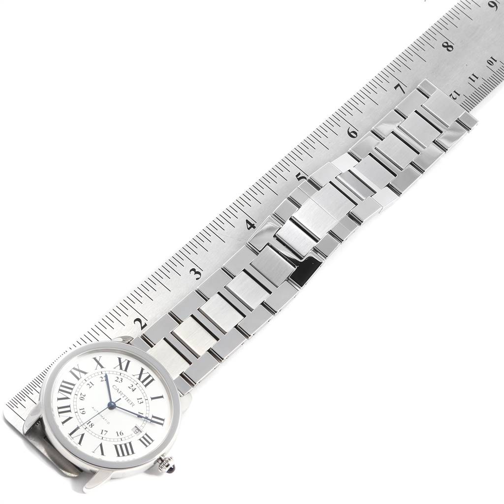 The image shows the front view of a Cartier Ronde W6701011 Men
s Stainless Steel Silver Dial W6701011 Men
s Stainless Steel Silver Dial model watch alongside a metal ruler for measuring the bracelet.