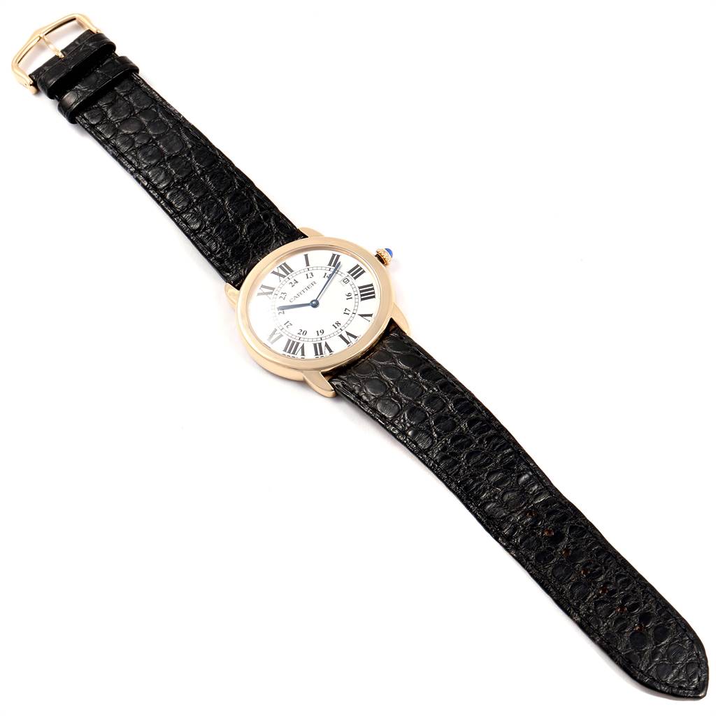 The image shows a Cartier Ronde W6700455 Men's Steel and Gold (two tone) Silver Dial W6700455 Men's Steel and Gold (two tone) Silver Dial watch with a full view of its face, black leather strap, buckle, and gold case from a top-down angle.