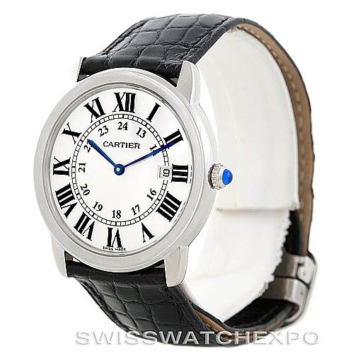 The Ronde model by Cartier is shown from an angled view, displaying its round dial, Roman numerals, black leather strap, and blue cabochon crown.
