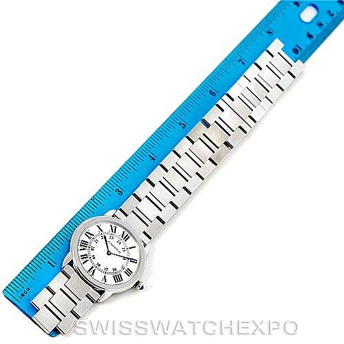 The Cartier Ronde W6701005 Men's Stainless Steel Silver Dial W6701005 Men's Stainless Steel Silver Dial watch is displayed face-up alongside a blue ruler, showing its stainless steel bracelet and Roman numeral dial.