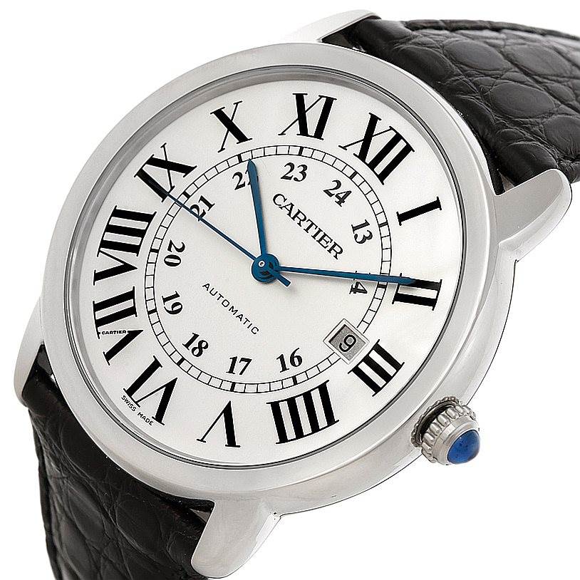 The image shows a close-up angle of the dial, crown, and black leather strap of the Ronde model by Cartier.