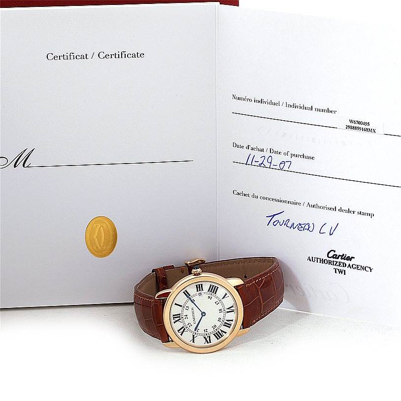 The image shows a Cartier Ronde W6700455 Men's Steel and Gold (two tone) Silver Dial W6700455 Men's Steel and Gold (two tone) Silver Dial watch facing upwards alongside its certificate and purchase paperwork.