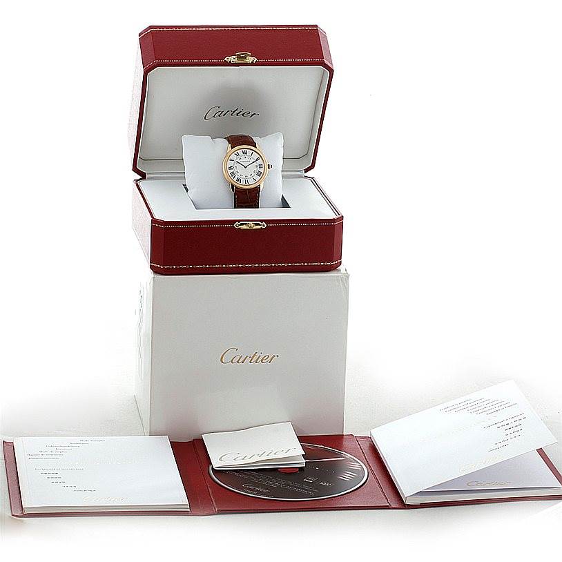 The image shows a Cartier Ronde W6700455 Men's Steel and Gold (two tone) Silver Dial W6700455 Men's Steel and Gold (two tone) Silver Dial watch in a red box, with a white outer box, manuals, and a CD nearby.