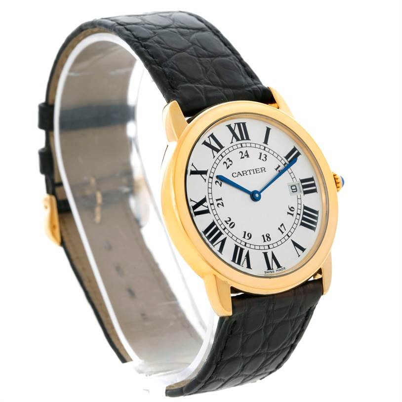 The Cartier Ronde W6700455 Men
s Steel and Gold (two tone) Silver Dial W6700455 Men
s Steel and Gold (two tone) Silver Dial watch is viewed from an angle showing its face, gold casing, and black leather strap.
