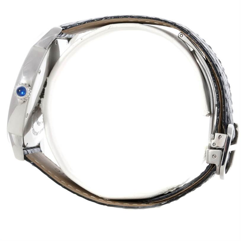 The image shows a side view of the Cartier Ronde W6701010 Men's Stainless Steel Silver Dial W6701010 Men's Stainless Steel Silver Dial watch, highlighting the side profile, bezel, crown with blue cabochon, and strap.