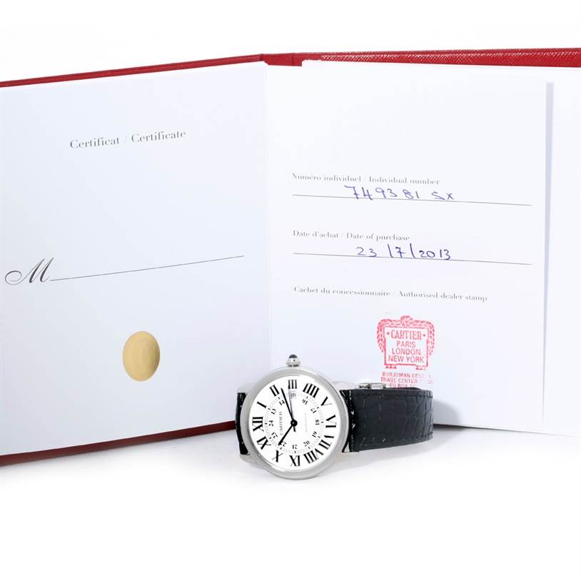 The image shows the Cartier Ronde W6701010 Men's Stainless Steel Silver Dial W6701010 Men's Stainless Steel Silver Dial watch placed in front of its open certificate booklet.