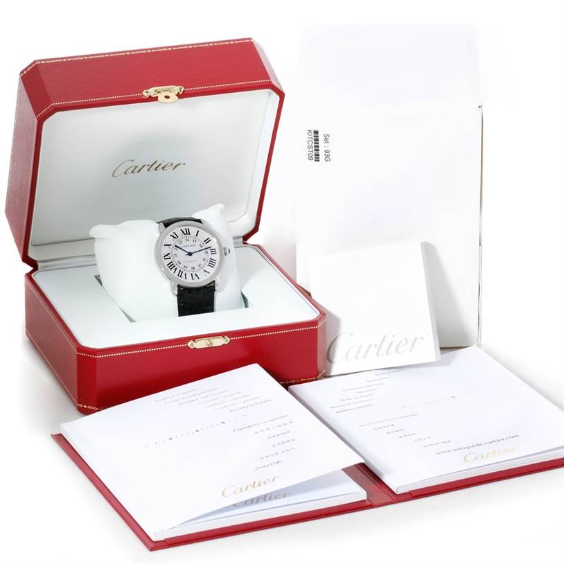 The Ronde model by Cartier is displayed frontally in its red box with accompanying documents and white packaging.