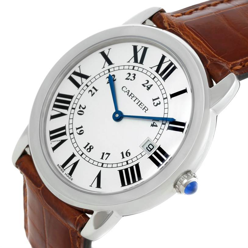 The image shows a close-up of the Cartier Ronde W6700255 Stainless Steel Silver Dial W6700255 Stainless Steel Silver Dial model watch, highlighting its face, blue hands, and brown leather strap.