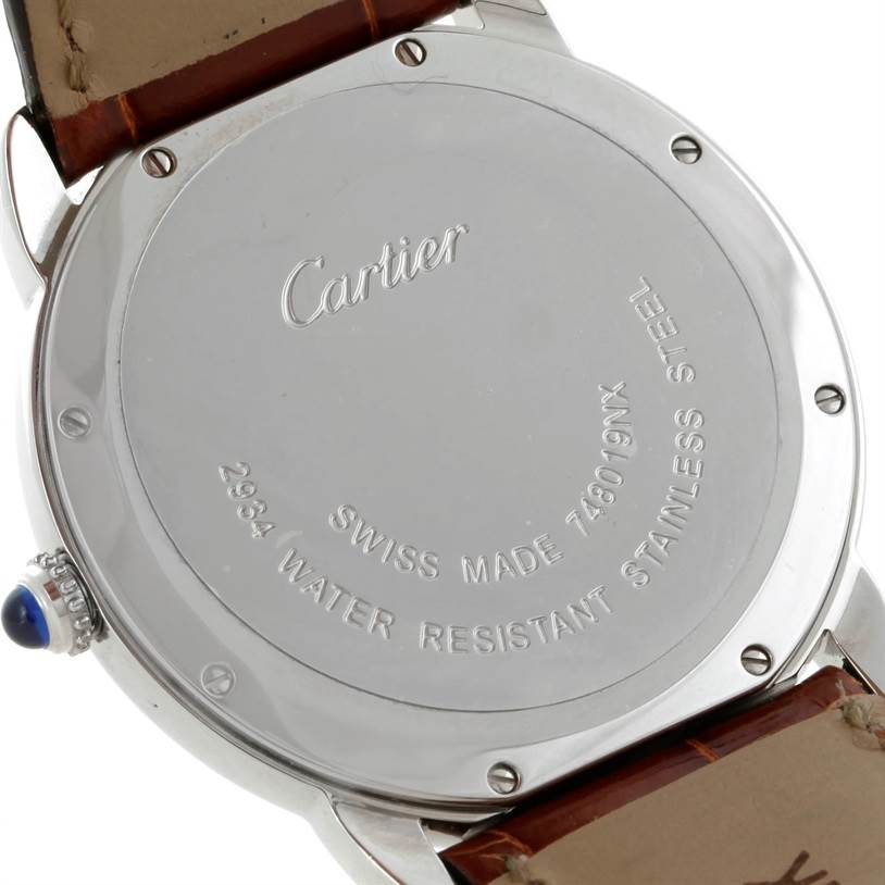 The image shows the back case and part of the strap of a Cartier Ronde W6700255 Stainless Steel Silver Dial W6700255 Stainless Steel Silver Dial model watch, displaying its inscriptions and screws.