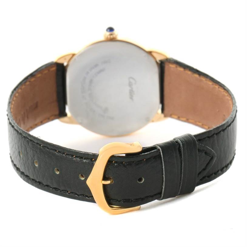 The image shows the back of the Cartier Ronde W6700355 Women's Steel and Gold (two tone) Silver Dial W6700355 Women's Steel and Gold (two tone) Silver Dial watch with its black leather strap and gold buckle in view.