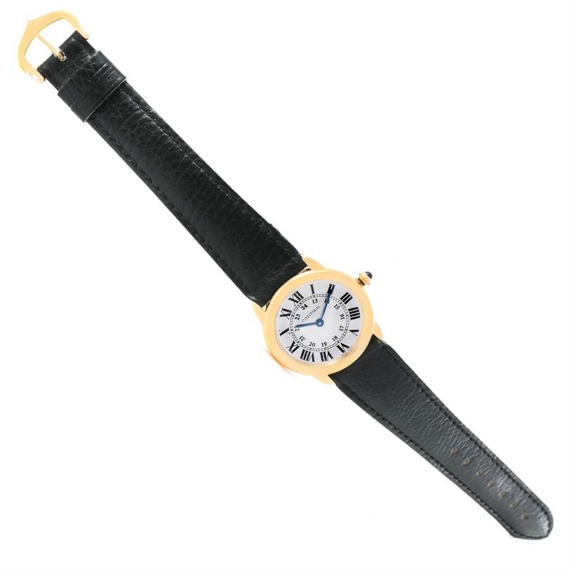 This image shows a top view of a Cartier Ronde W6700355 Women's Steel and Gold (two tone) Silver Dial W6700355 Women's Steel and Gold (two tone) Silver Dial model watch, featuring its full strap and round face.