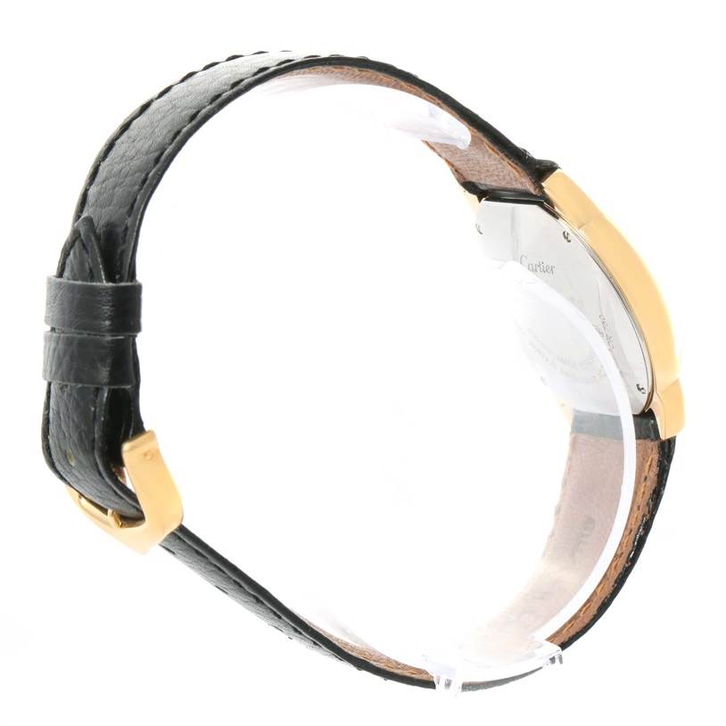 This side view of the Ronde model by Cartier shows the watch strap and back of the case with a gold buckle.