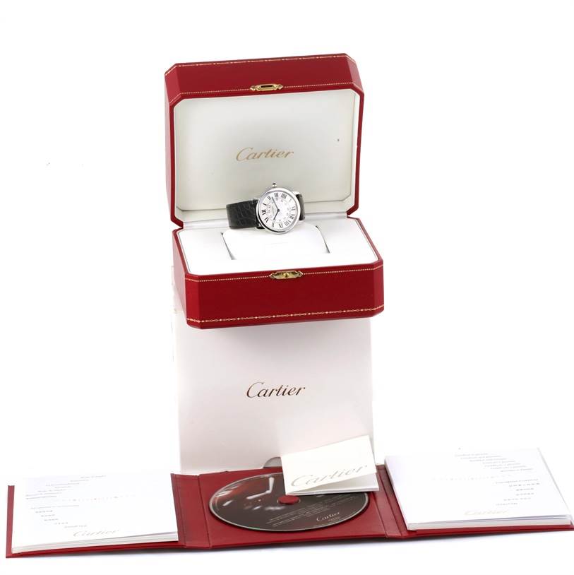 The Cartier Ronde W6700255 Stainless Steel Silver Dial W6700255 Stainless Steel Silver Dial watch is shown from the front, inside its red box, along with its CD, booklet, and warranty card.