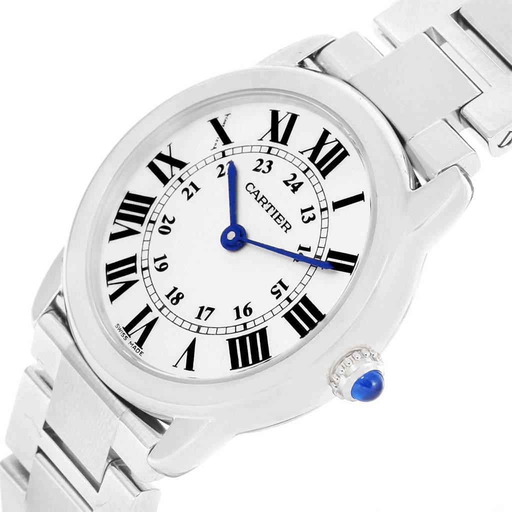 The Ronde model by Cartier is shown at a slight angle, highlighting the face, bracelet, and crown with a blue cabochon.