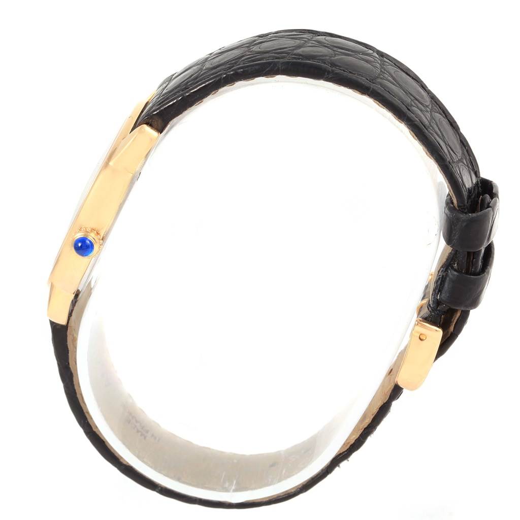 The image shows a side view of the Cartier Ronde W6700355 Women
s Steel and Gold (two tone) Silver Dial W6700355 Women
s Steel and Gold (two tone) Silver Dial model watch, highlighting its black strap and gold crown with a blue cabochon.