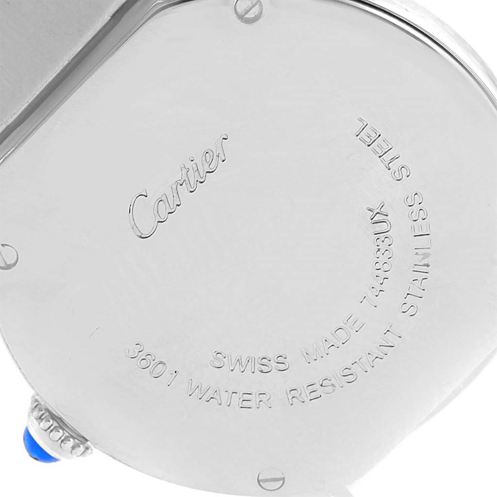 This image shows the back of the Cartier Ronde W6701004 Women
s Stainless Steel Silver Dial W6701004 Women
s Stainless Steel Silver Dial watch, highlighting its inscriptions and a portion of the crown with a blue cabochon.