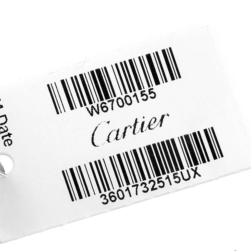 This image shows a close-up of a tag for the Cartier Ronde W6700155 Women's Stainless Steel Silver Dial W6700155 Women's Stainless Steel Silver Dial model with barcodes and text.