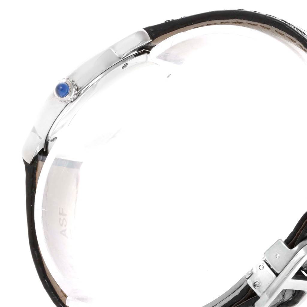 This side angle view of the Cartier Ronde W6700155 Women's Stainless Steel Silver Dial W6700155 Women's Stainless Steel Silver Dial watch shows its crown, case, and part of the leather strap.