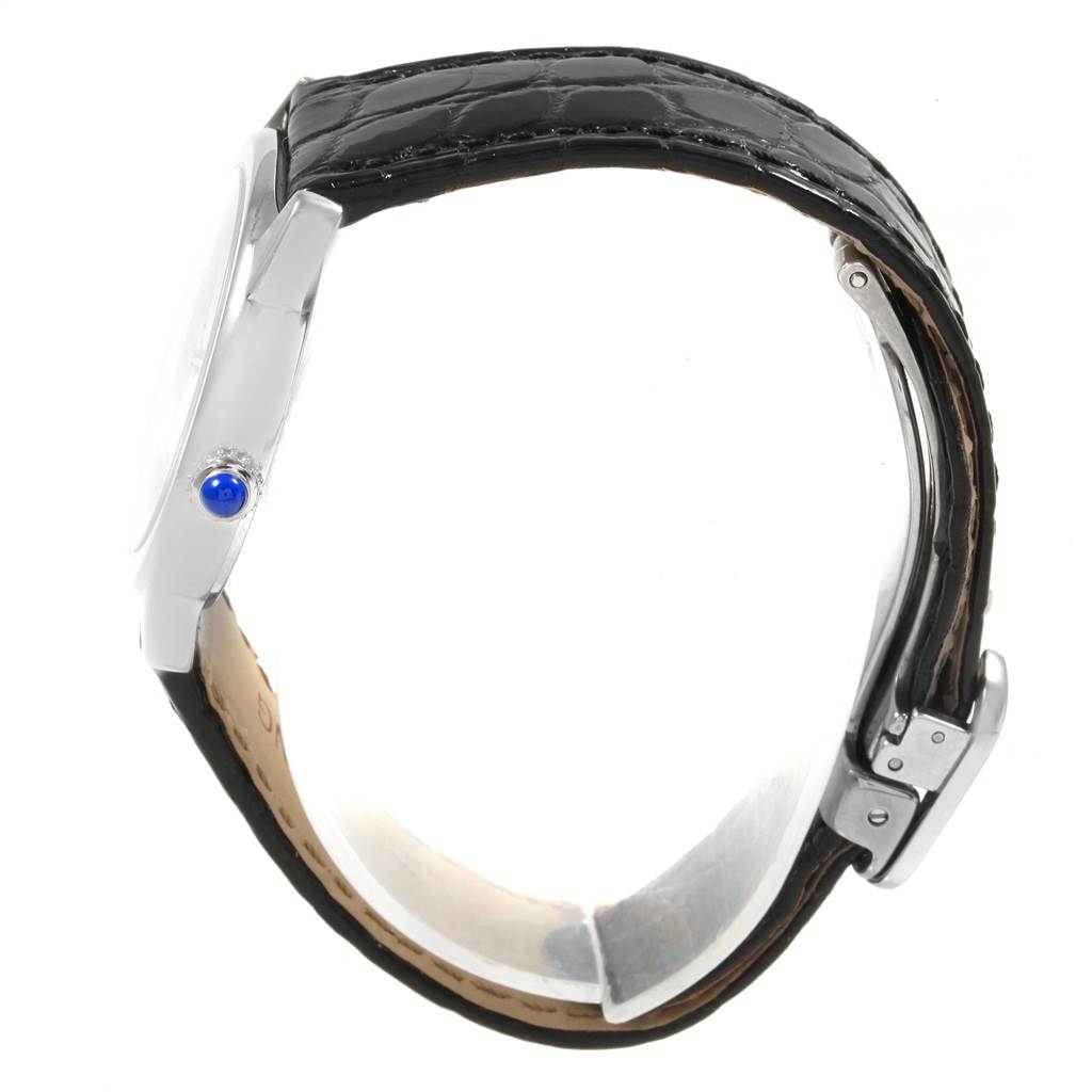 The image shows a side view of the Cartier Ronde W6700155 Women's Stainless Steel Silver Dial W6700155 Women's Stainless Steel Silver Dial watch, highlighting its crown with the blue cabochon, black strap, and clasp.