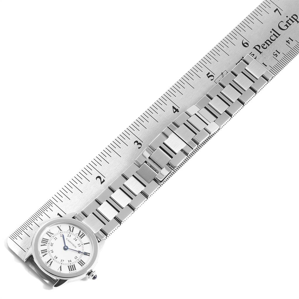 A Cartier Ronde W6701004 Women's Stainless Steel Silver Dial W6701004 Women's Stainless Steel Silver Dial model watch is aligned diagonally with a ruler, showing the face and full metal strap.