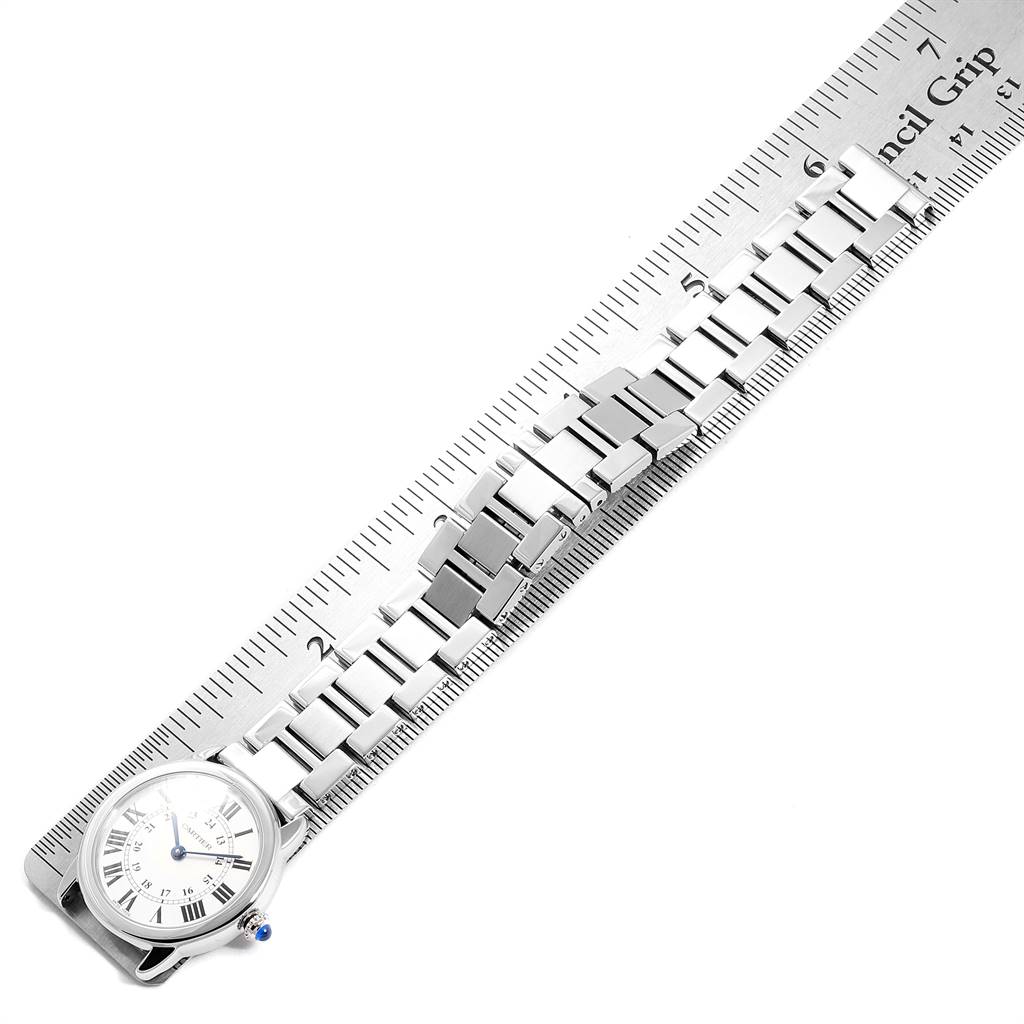 The Cartier Ronde W6701004 Women's Stainless Steel Silver Dial W6701004 Women's Stainless Steel Silver Dial watch is shown in a top-down view with a focus on its face and metal bracelet against a ruler.