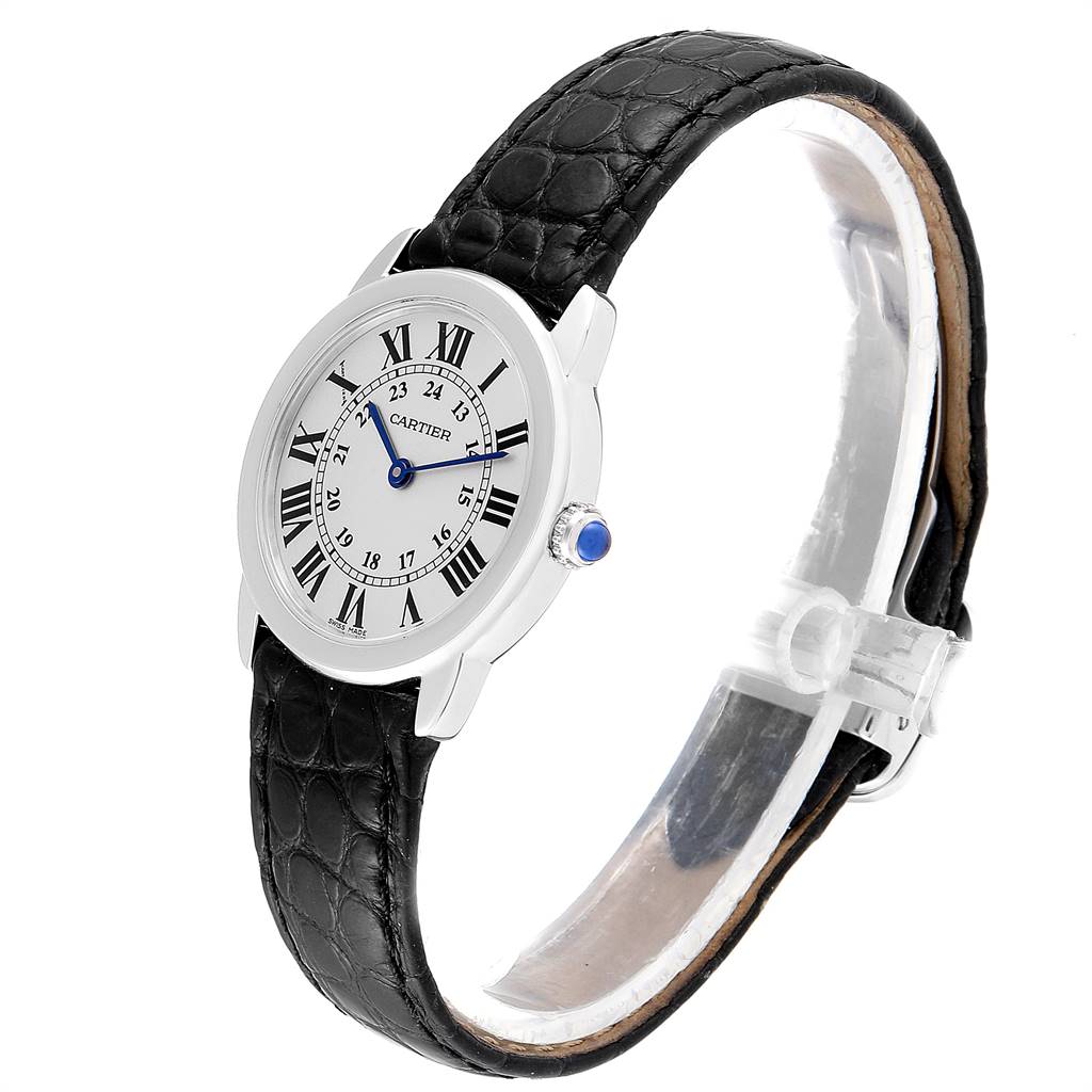 The image shows a Ronde model by Cartier from a 3/4 angle, highlighting its black leather strap and Roman numeral dial.
