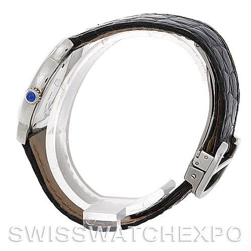 The image shows a side view of a Ronde model by Cartier, highlighting the black leather strap, buckle, and crown with a blue gemstone.