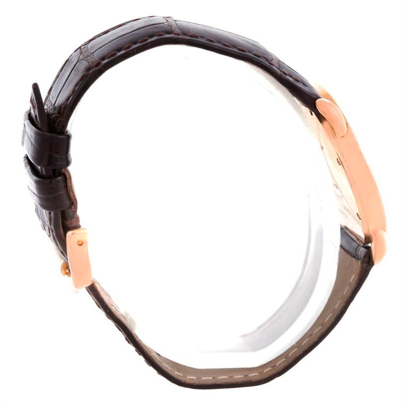 The image shows a side view of a Cartier Ronde W6800151 Women
s Rose Gold Silver Dial W6800151 Women
s Rose Gold Silver Dial watch, highlighting its brown leather strap and gold-toned case.