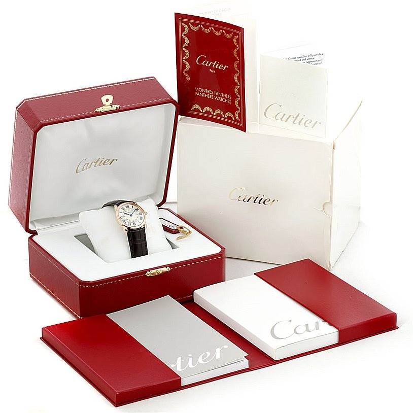 The image shows a Ronde model by Cartier in its open box, along with booklets and documentation.