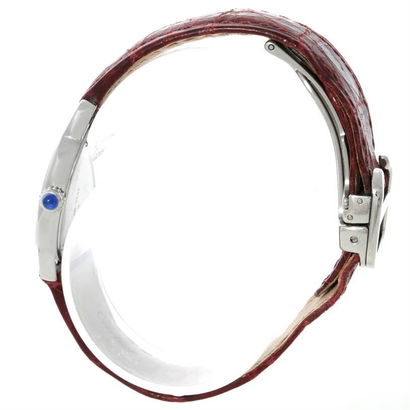 The image shows a side view of a Cartier Ronde W6700155 Women
s Stainless Steel Silver Dial W6700155 Women
s Stainless Steel Silver Dial watch, highlighting its red leather strap and the blue cabochon crown.