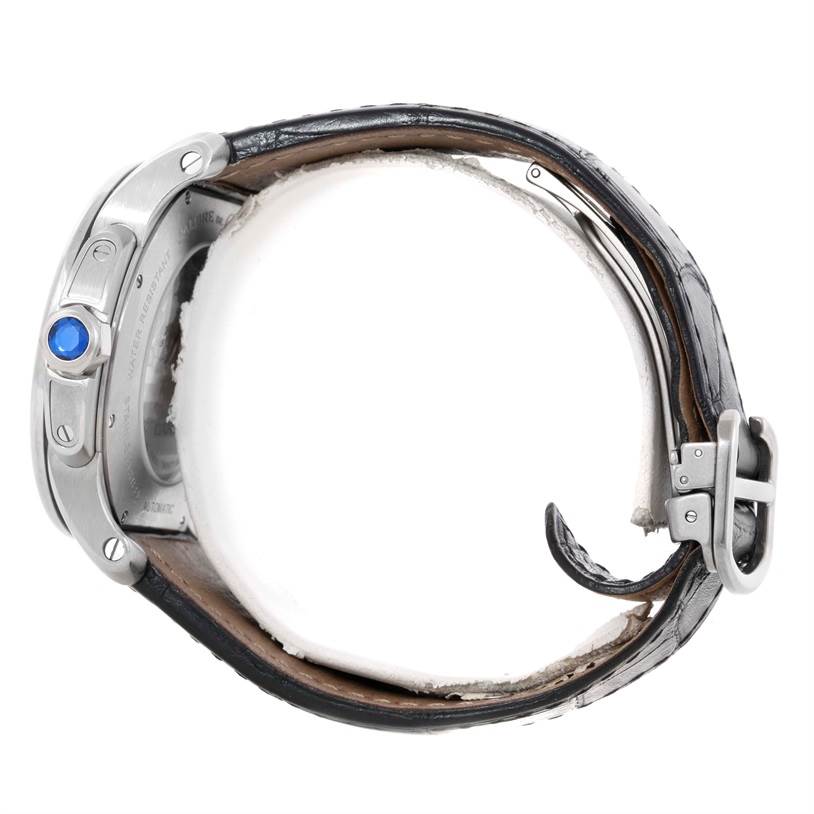 This image shows a side view of a Calibre de Cartier watch by Cartier, highlighting the crown with a blue cabochon and leather strap.