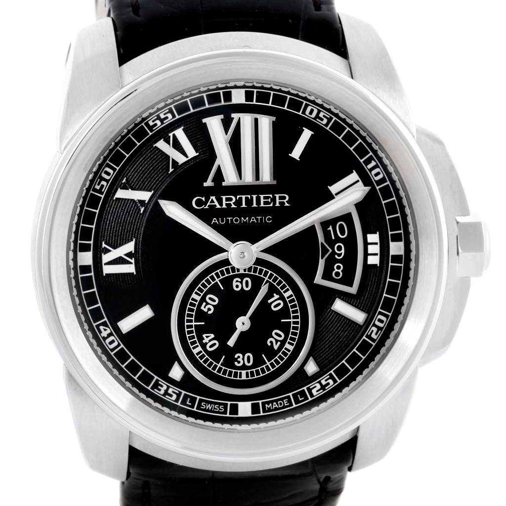 This image shows a front view of the Calibre de Cartier watch by Cartier, showcasing its black dial, silver hands, Roman numerals, and subdial.