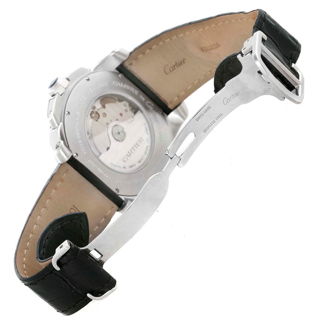 This image shows the back view of a Calibre de Cartier watch by Cartier, featuring the movement and leather strap with clasp.