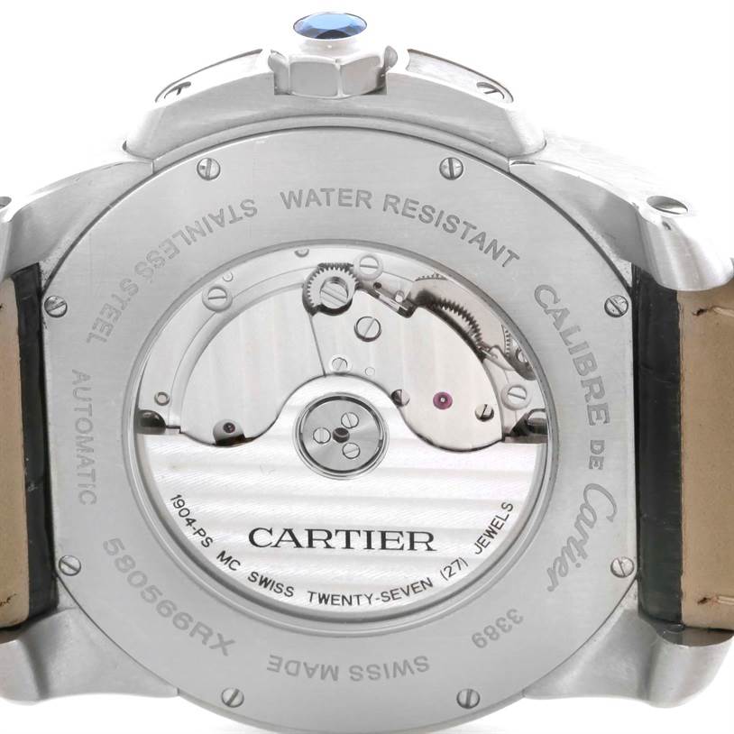 The image shows the back view of a Calibre de Cartier watch by Cartier, highlighting the movement and engravings.