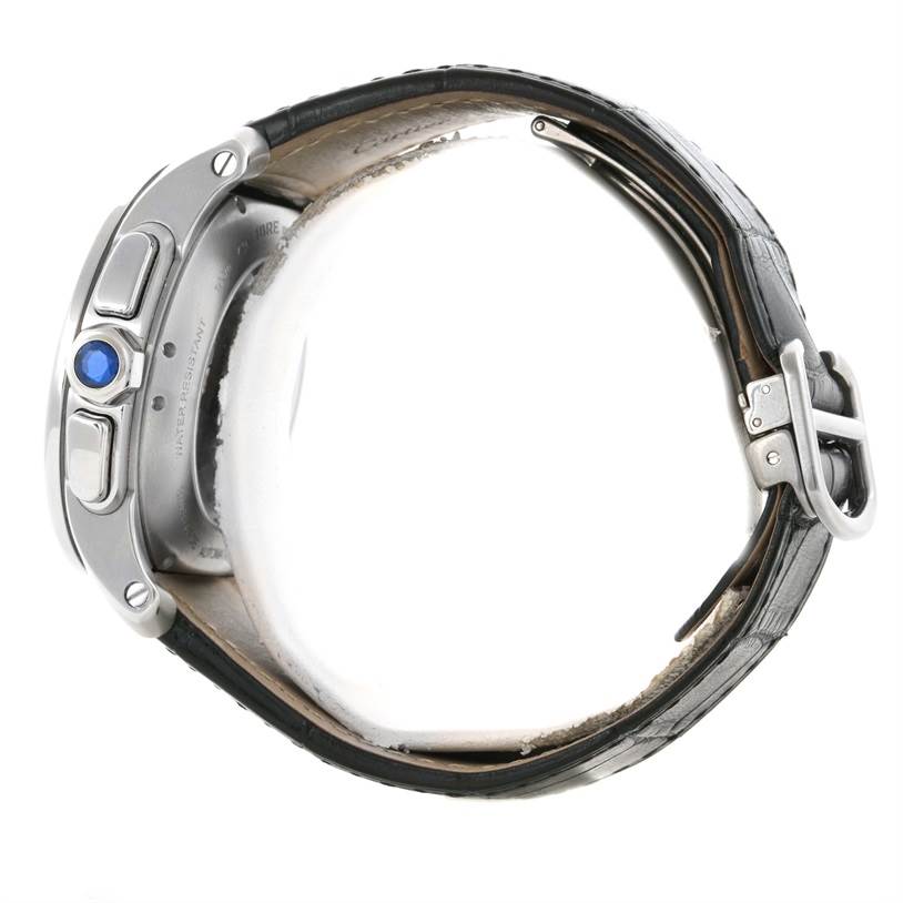 The image shows the side view of the Calibre de Cartier watch by Cartier, highlighting the crown and strap buckle.