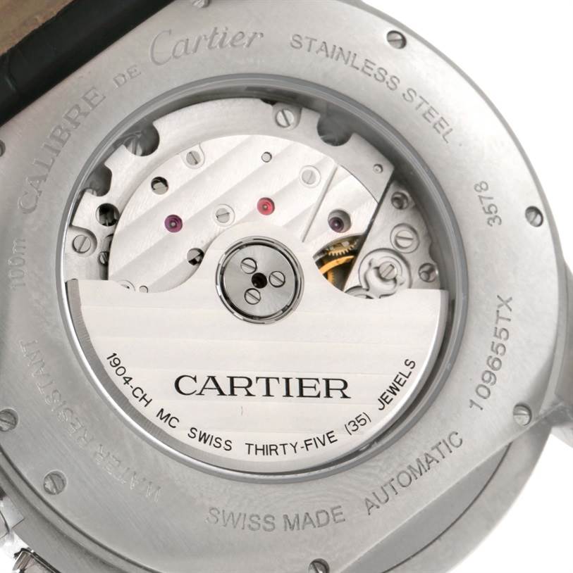 The image shows the back view of a Calibre de Cartier watch by Cartier, highlighting the automatic movement and rotor details.