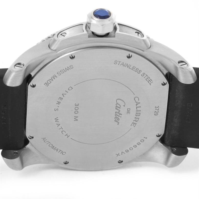 The image shows the back and sides of a Calibre de Cartier watch, highlighting its case back engravings and crown with a blue cabochon.