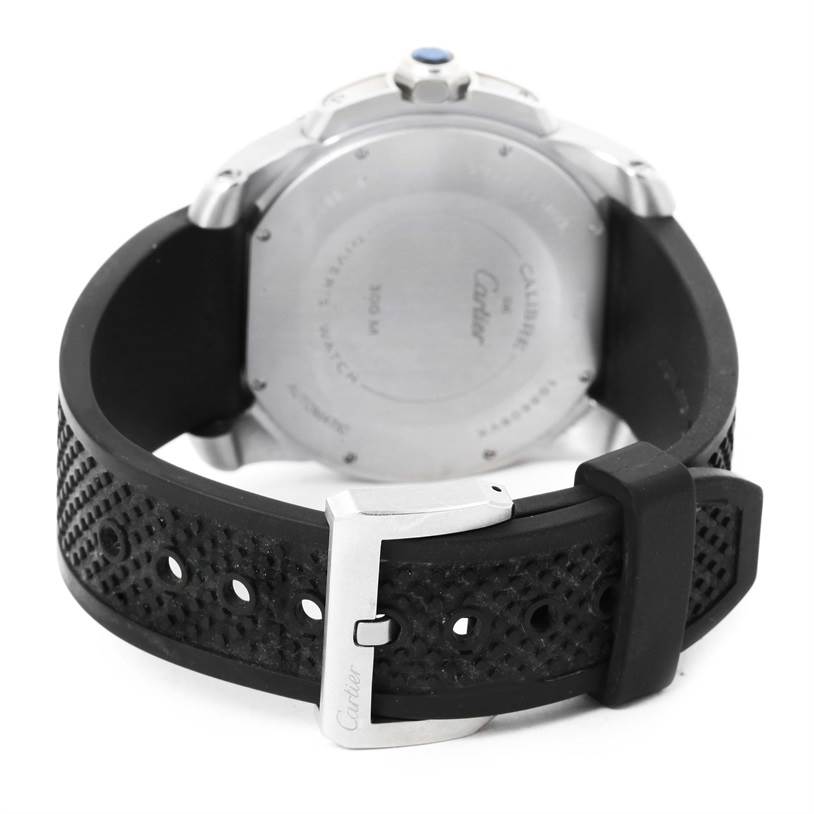 The image shows a rear angle of the Calibre de Cartier model by Cartier, highlighting the back case, black strap, and silver buckle.