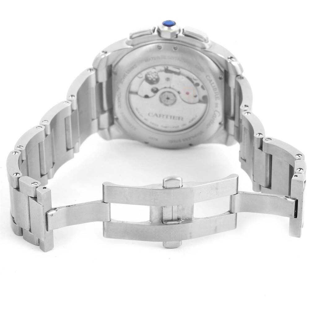 This image displays the back angle of a Calibre de Cartier watch by Cartier, showcasing its open clasp and movement.