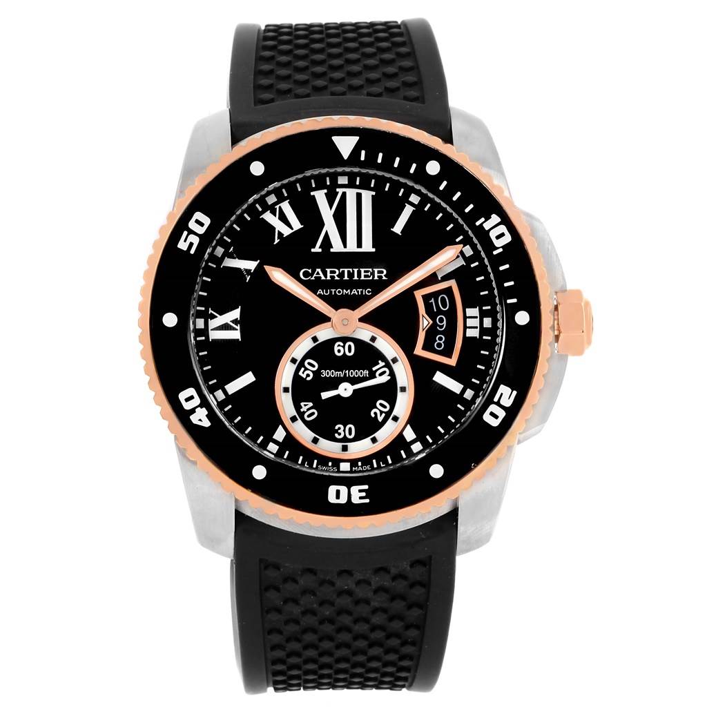 The image shows a front view of the Calibre de Cartier watch by Cartier, featuring a black dial, Roman numerals, and a rubber strap.