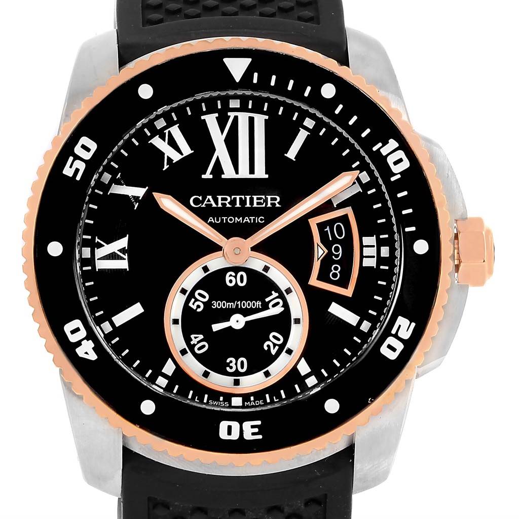 The image shows a Calibre de Cartier model watch from Cartier, featuring the dial, bezel, and crown from a front angle.